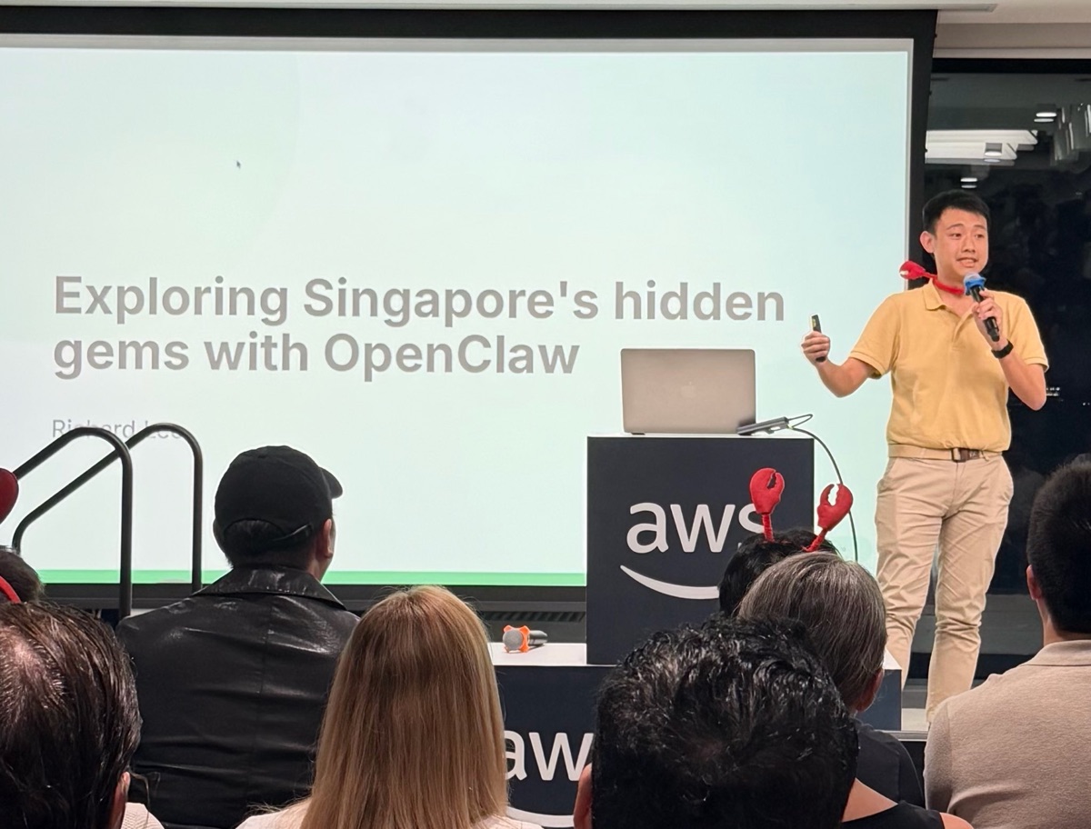 Speaker presenting beside a projected slide at ClawCon Singapore