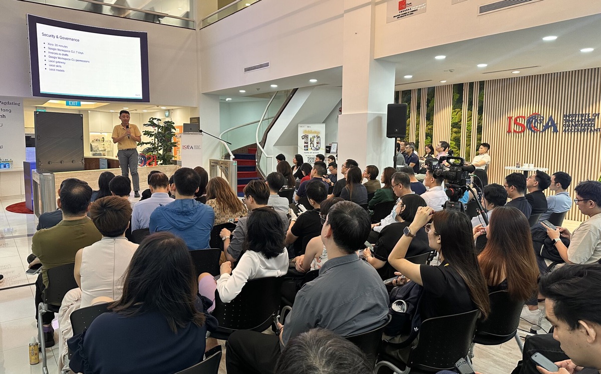 Stage and seated audience at a finance workflows presentation with ISCA branding