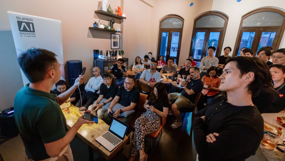 Speaker holding a connected device in front of a seated audience