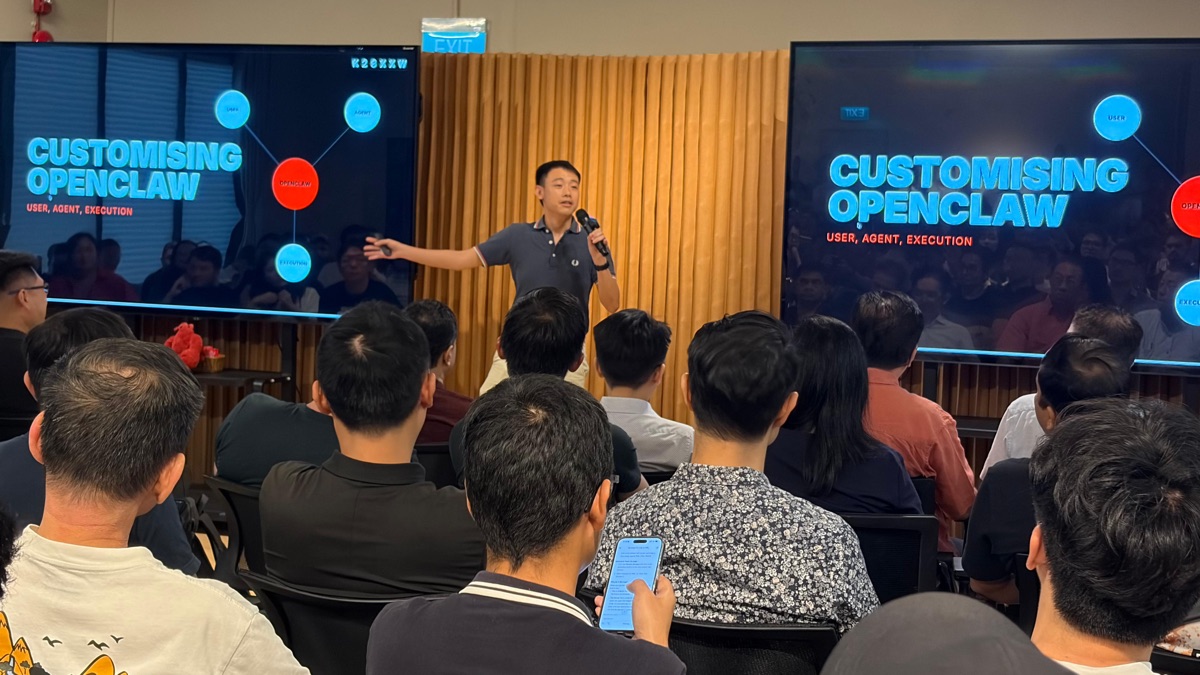 Speaker between two Customising OpenClaw screens addressing the audience
