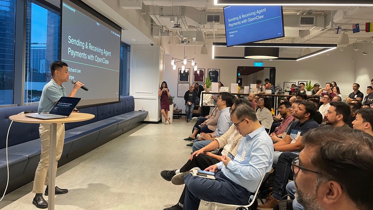 Speaker and seated audience beside the Sending and Receiving Agent Payments with OpenClaw title screen